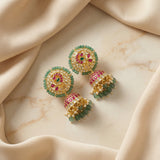 Jadau kundan peacock jhumkas with pearl and natural strawberry beads drop