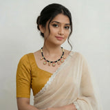 Jadau kundan black thread bottu and mango necklace