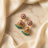 Jadau kundan peacock jhumkas with pearl and natural strawberry beads drop