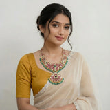 Jadau kundan floral bridal necklace with pearls and natural strawberry beads drop