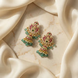 Jadau kundan peacock jhumkas with pearl drops and natural strawberry beads