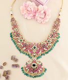 Jadau kundan floral bridal necklace with pearls and natural strawberry beads drop