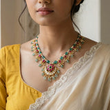 Jadau kundan floral half moon pendant with pearl and natural strawberry beads